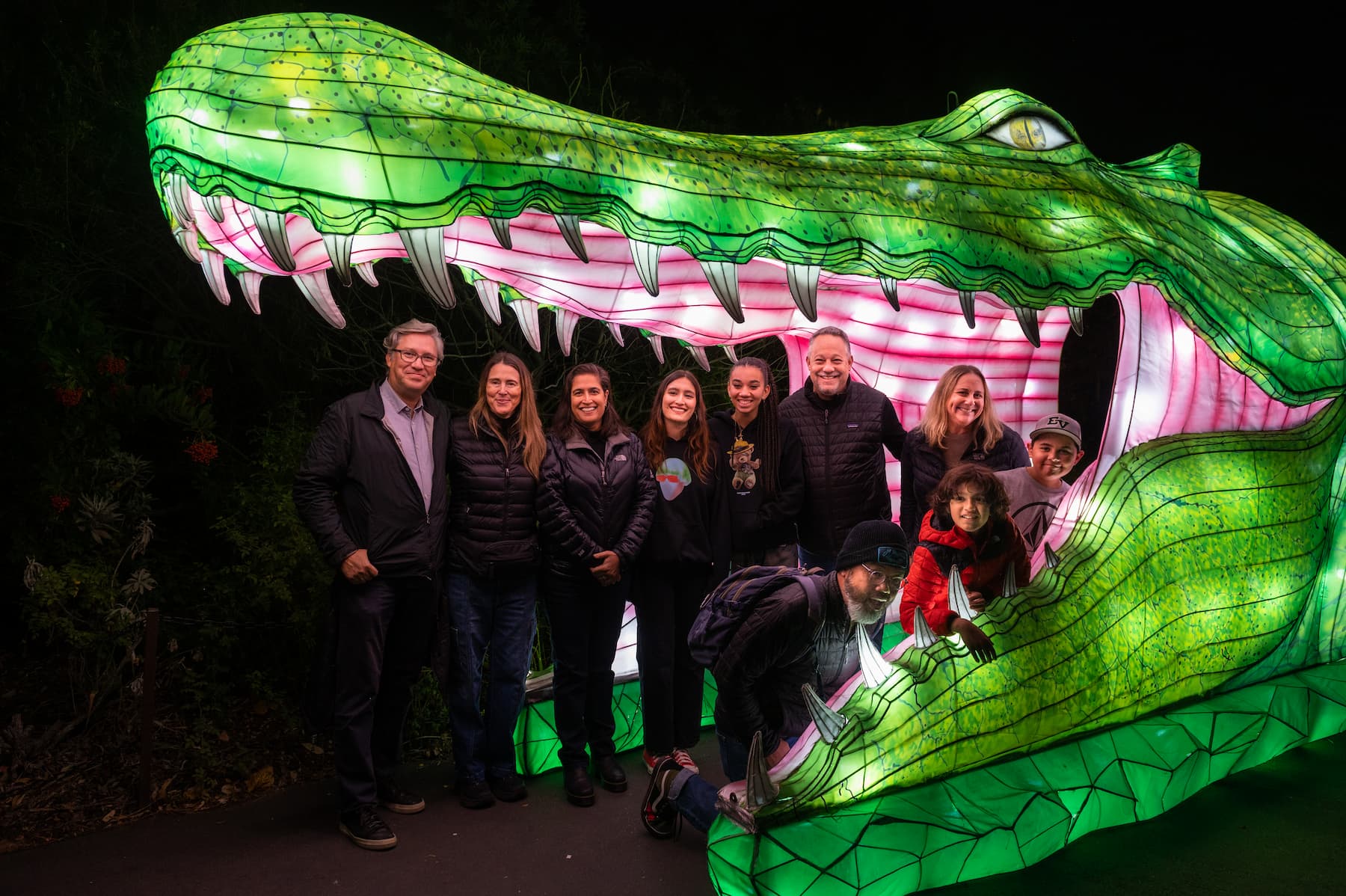 A group standing inside a giant alligator lantern