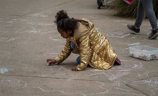 Little girls draws during Chalk Talk time at the LA Zoo.