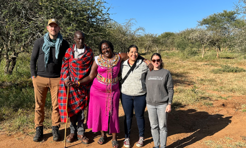 The team poses with Rosemary Nenini, manager of Twala Women's Cultural Center, and her husband, Edward.