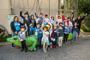 Zoo Pals children pose with the lizard.