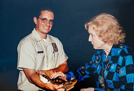 Ian Recchio holds a lizard so actress Betty White can view it up close.